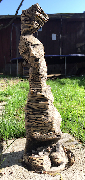 Ceramic chiminea with a face